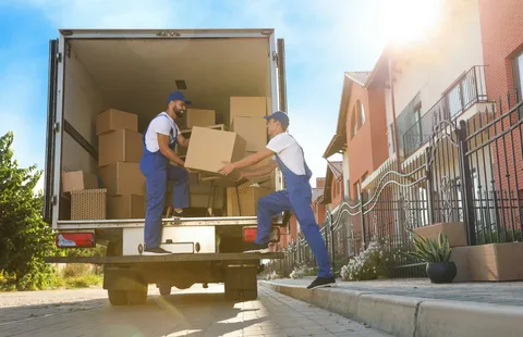 Movers loading boxes into a truck during a residential relocation