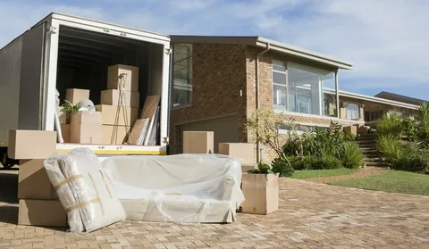 Furniture and boxes outside a home during a move.