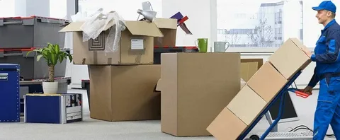Office relocation with packed boxes and mover.