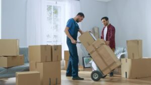 Professional movers handling packed boxes during home relocation