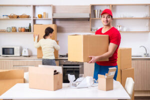 Man and woman packing cardboard boxes while moving to a new home.