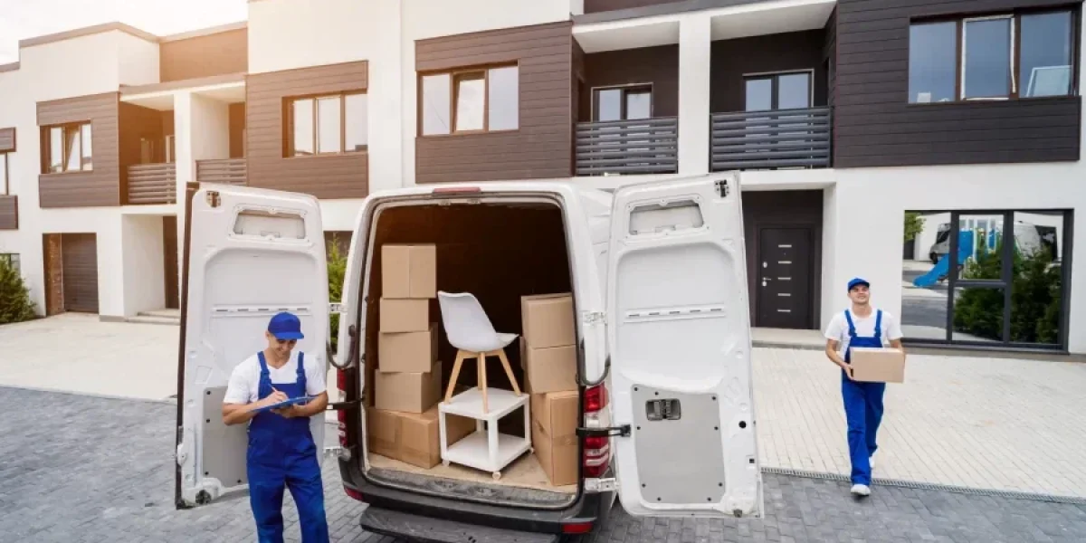 Professional movers unloading boxes from moving van