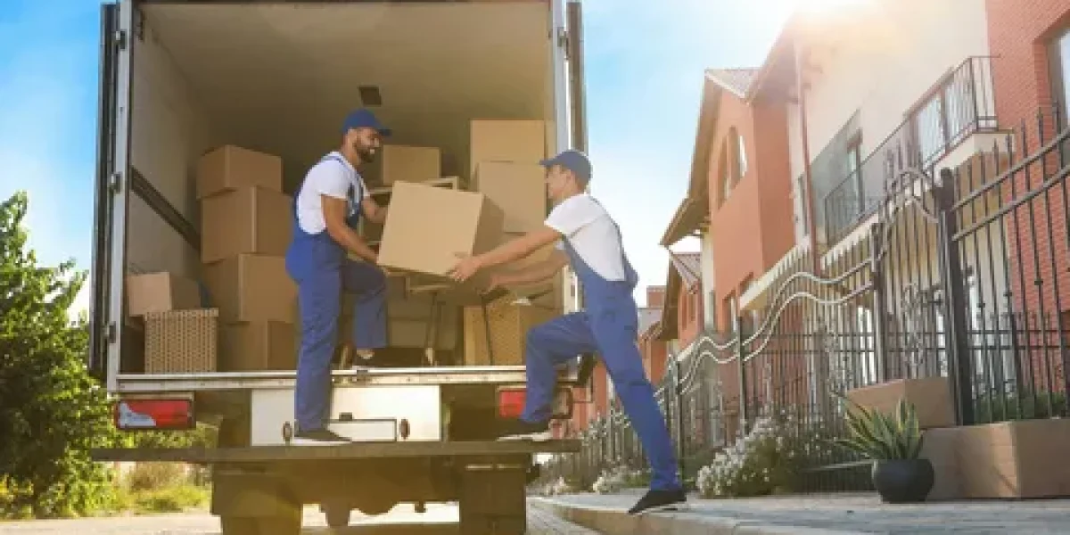 Movers loading boxes into a truck during a residential relocation